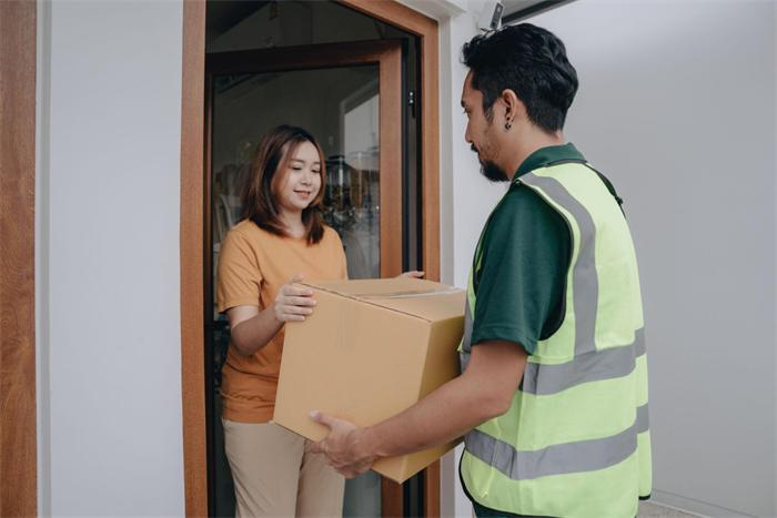 Adult recipient signing for Chunghwa Cigarettes delivery at the door